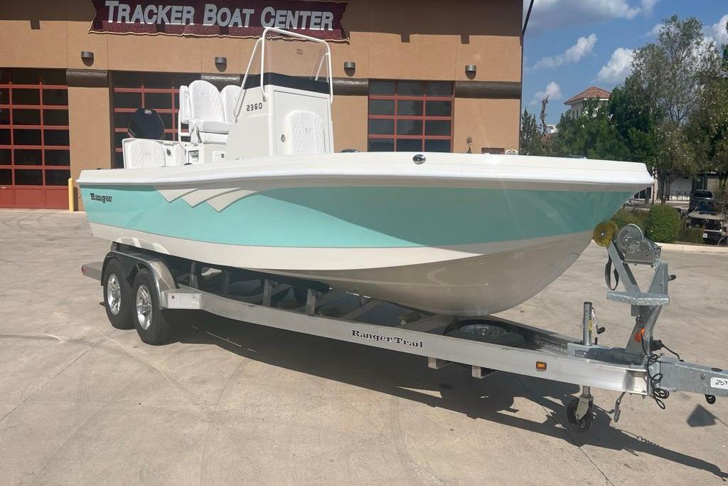 Ranger 2360 Bay 2025 Ranger 2360 Bay boat on trailer at Tracker Boat Center, sunny day.
