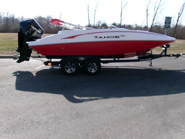 Tahoe 2150 2025 Tahoe 2150 boat on trailer, red and white design, parked outdoors.
