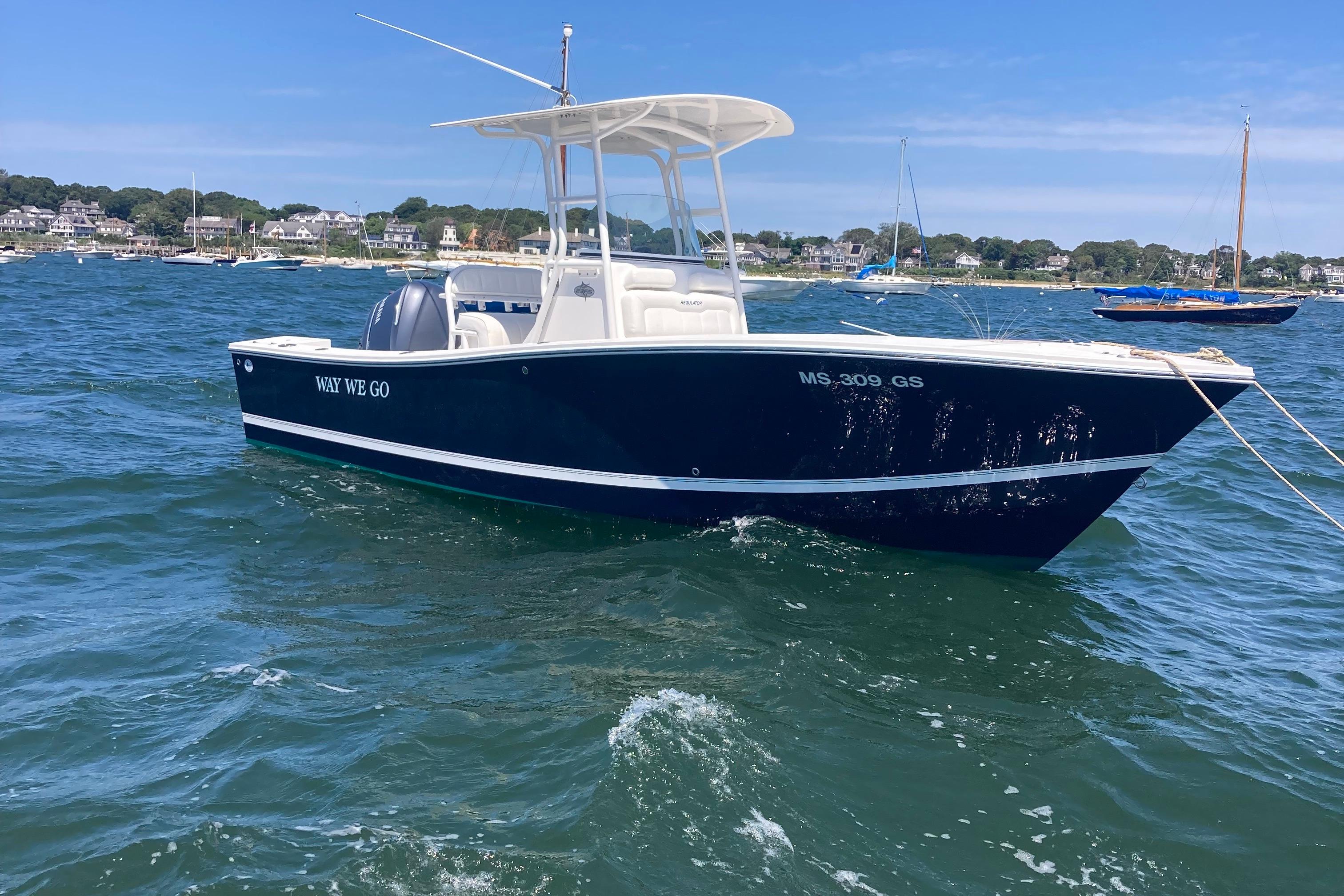 Regulator 23 Forward Seating 2015 Regulator 23 Forward Seating boat on water, clear sky, coastal background.