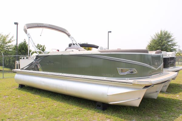 Tahoe LTZ Cruise 2021 Tahoe LTZ Cruise pontoon boat on grass, featuring sleek design and canopy.
