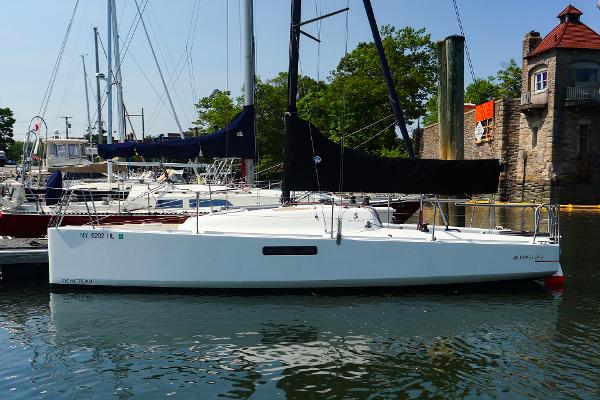 Beneteau First 27 SE 2021 Beneteau First 27 SE sailboat docked in a marina, surrounded by other boats.