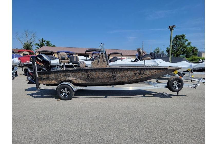 Xpress H20B Bay 2026 Xpress H20B Bay boat on trailer, parked outdoors under clear blue sky.