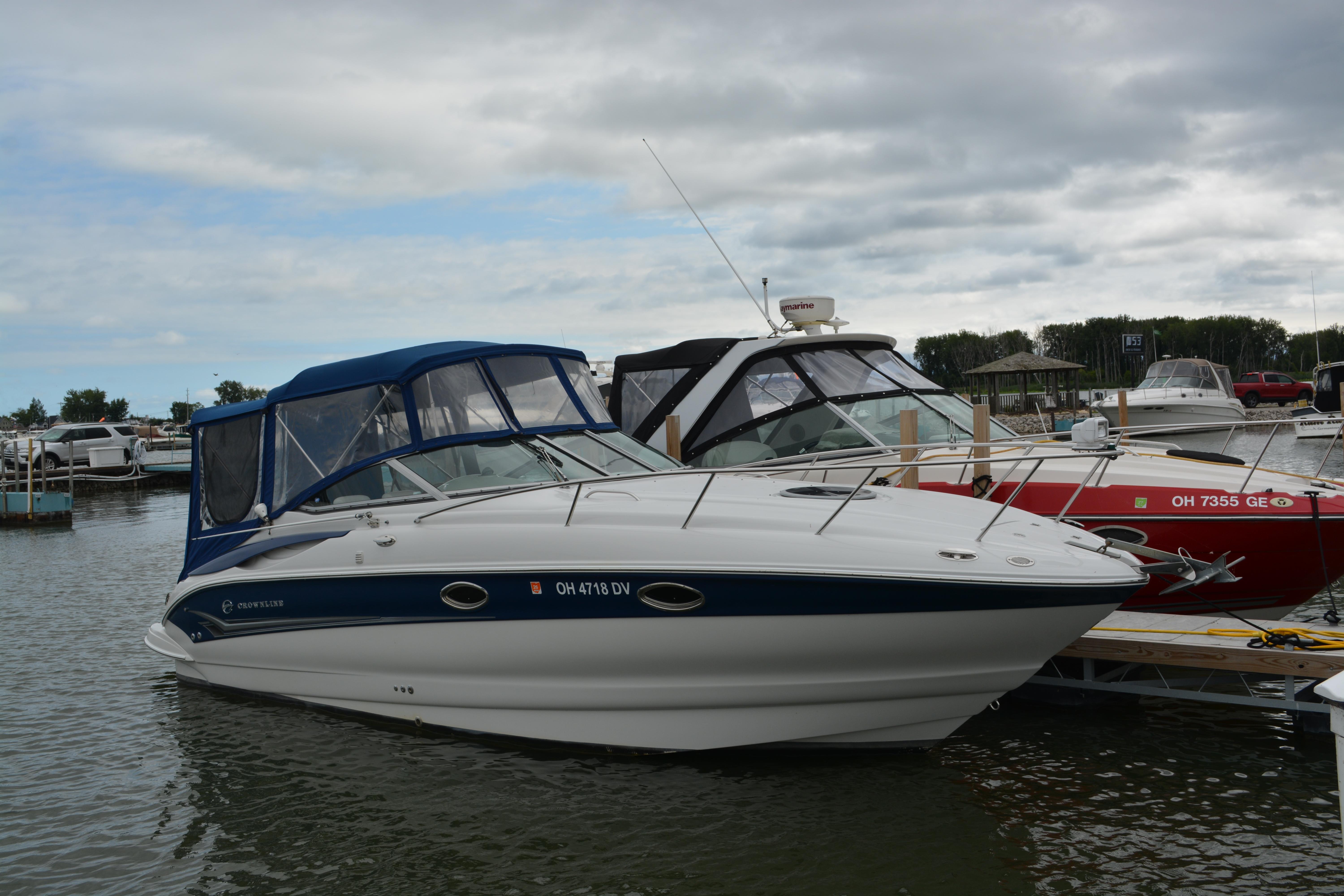 Crownline 270 CR 2004 Crownline 270 CR boat docked at marina under cloudy sky.