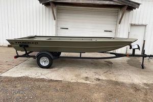 Tracker Grizzly 1754 Jon 2025 Tracker Grizzly 1754 Jon boat on trailer, parked outside a garage.