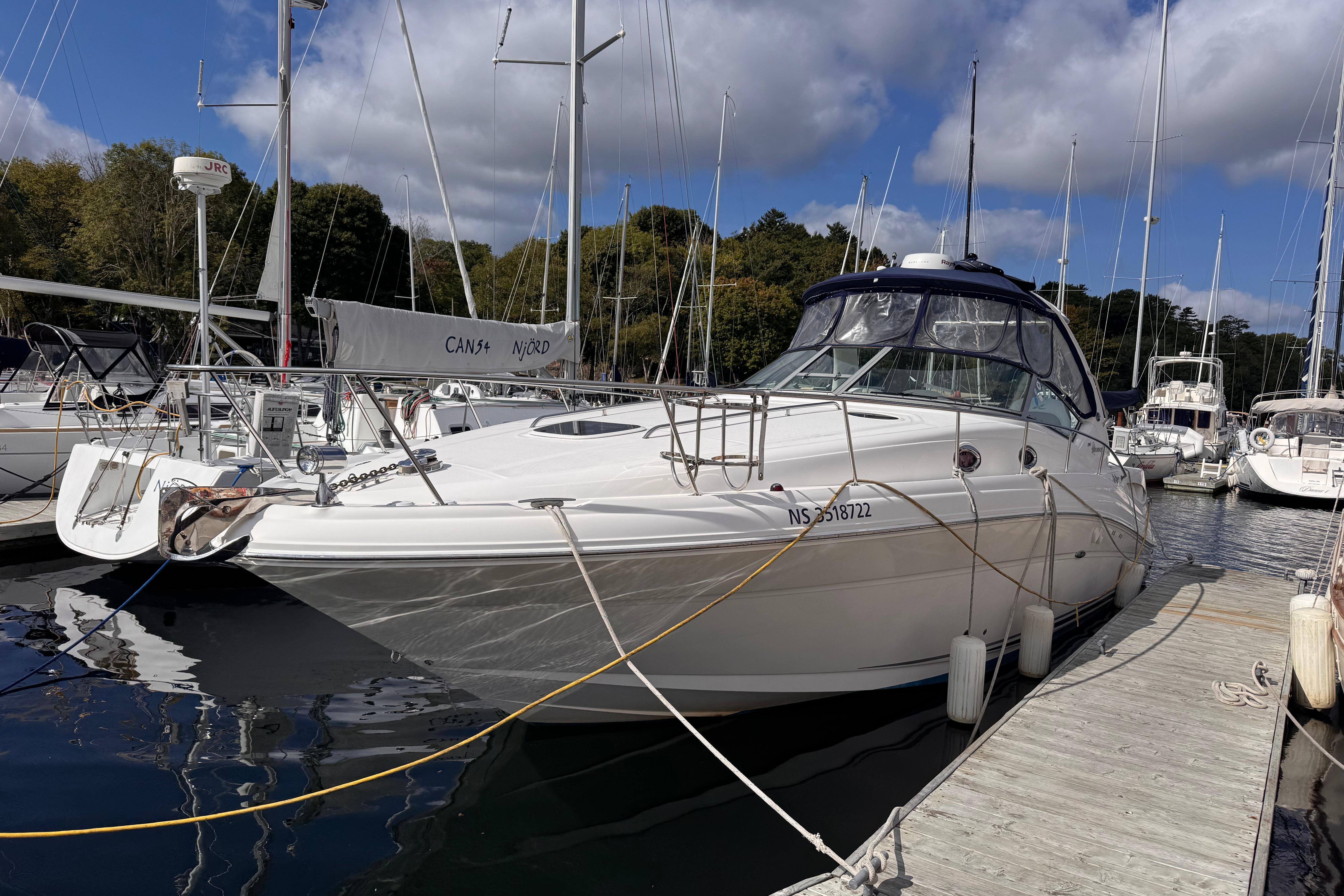 Sea Ray 340 Sundancer 2007 Sea Ray 340 Sundancer docked at marina, surrounded by sailboats under a partly cloudy sky.