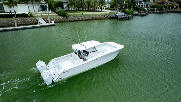 Front Runner 37 Catamaran 2025 Front Runner 37 Catamaran cruising on a calm waterway near waterfront homes.