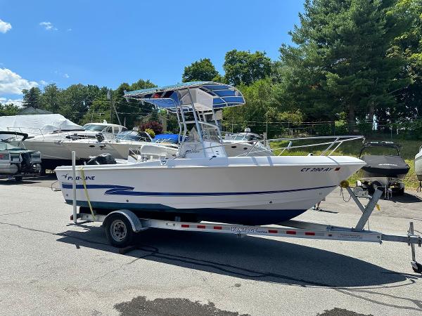 Pro-Line 20 Sport 2002 Pro-Line 20 Sport boat on a trailer in a marina parking lot.