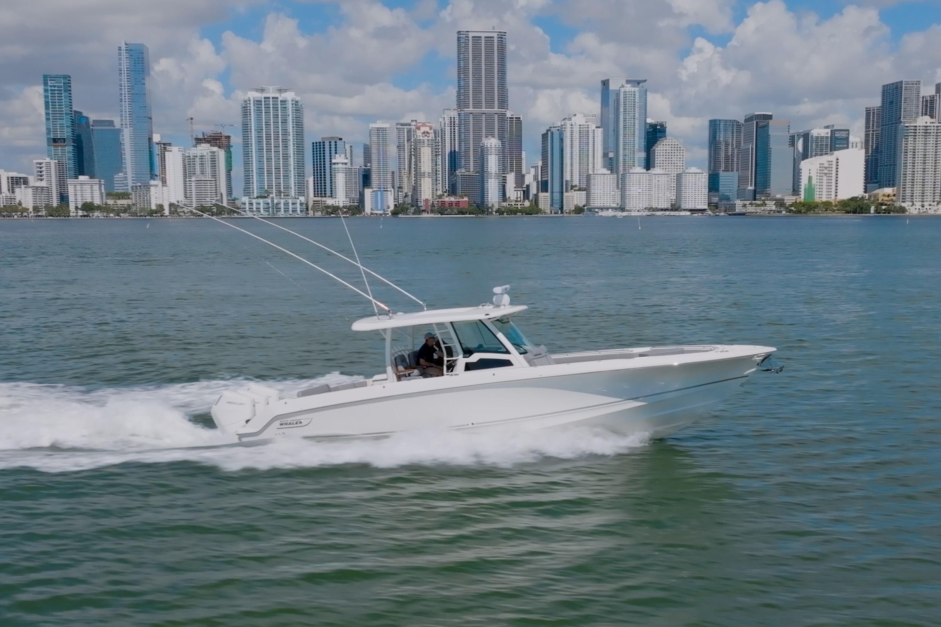 Boston Whaler 380 Outrage 2025 Boston Whaler 380 Outrage cruising near city skyline on a sunny day.