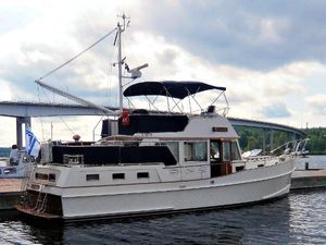 Grand Banks 42 Motoryacht 1996 Grand Banks 42 Motoryacht docked, featuring classic design and spacious deck under cloudy skies.