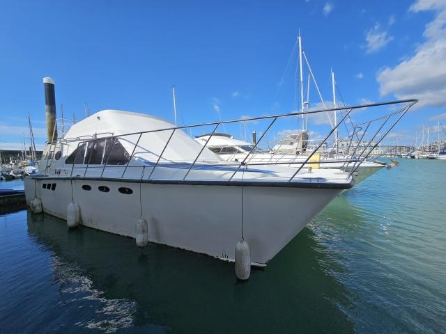 Custom Converted Catamaran Workboat Style Liveaboard 1980 Custom Converted Catamaran Workboat Style Liveaboard docked in a marina under blue skies.