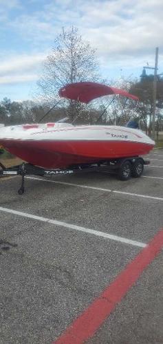 Tahoe 2150 2025 Tahoe 2150 boat with red and white design on a trailer in a parking lot.