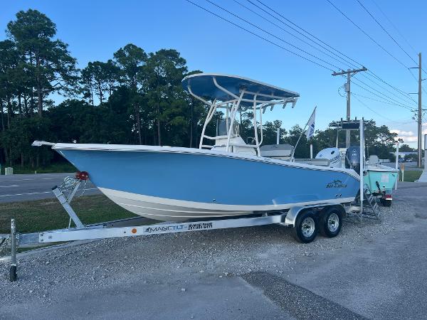 Sea Chaser 22 HFC 2024 Sea Chaser 22 HFC boat on trailer, parked roadside, blue and white design.