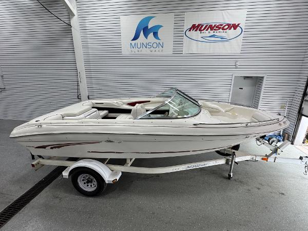 Sea Ray 185 Bow Rider 1997 Sea Ray 185 BR boat on trailer in showroom with Munson signage.