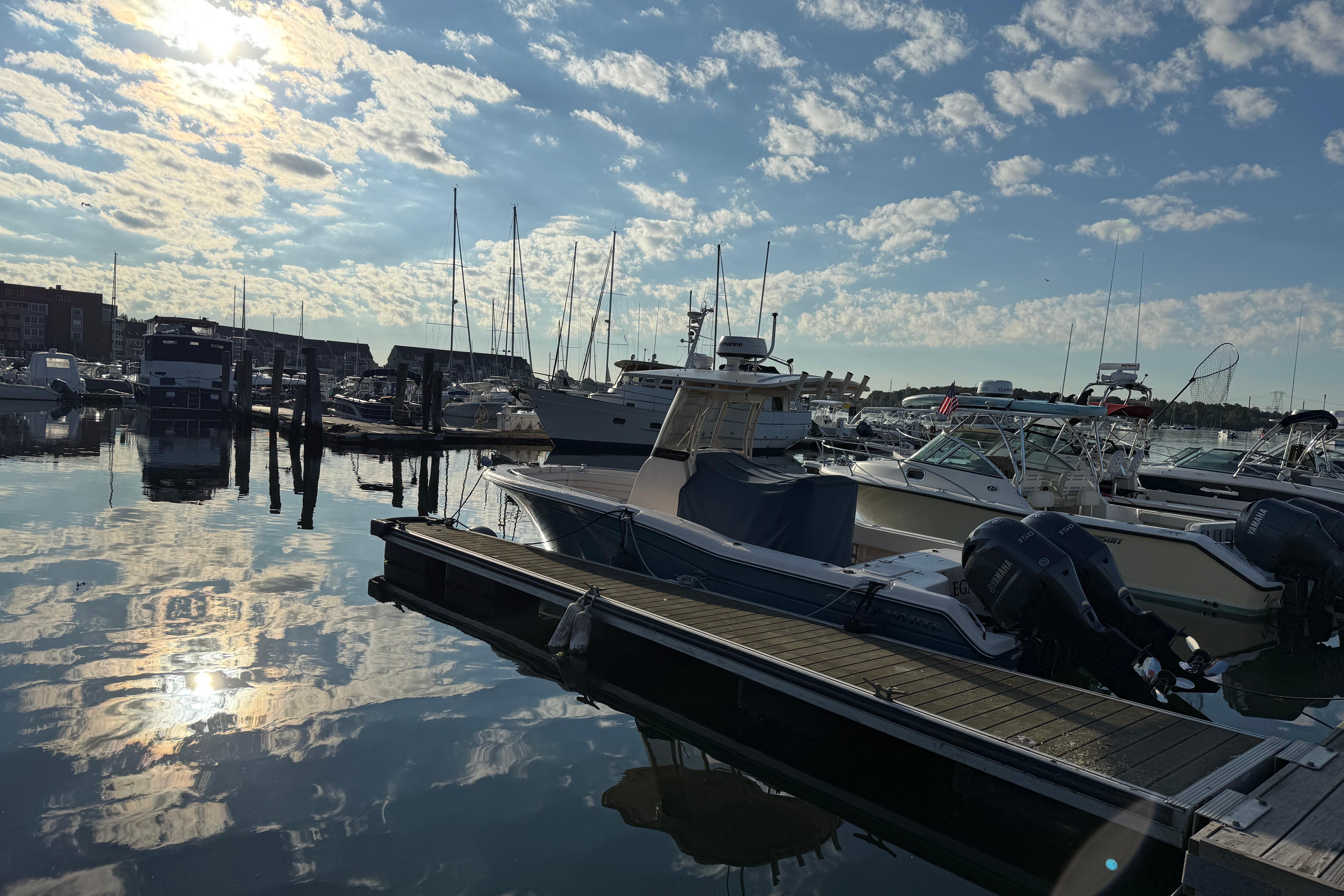 Grady-White Fisherman 257 Boats docked at a marina under a partly cloudy sky, featuring a 2017 Grady White 257 Fisherman.