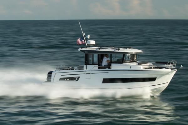 Jeanneau NC Sport 895 2024 Jeanneau NC Sport 895 cruising on open water, American flag flying.