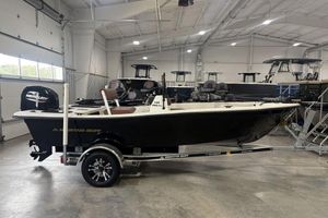 Skiff 160 PRO-Vee 2024 Skiff 160 PRO-Vee boat in showroom, black hull, Mercury engine, on trailer.