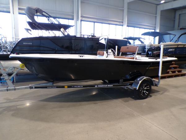 Skiff 160 PRO-Vee 2024 Skiff 160 PRO-Vee boat on a trailer in a showroom.