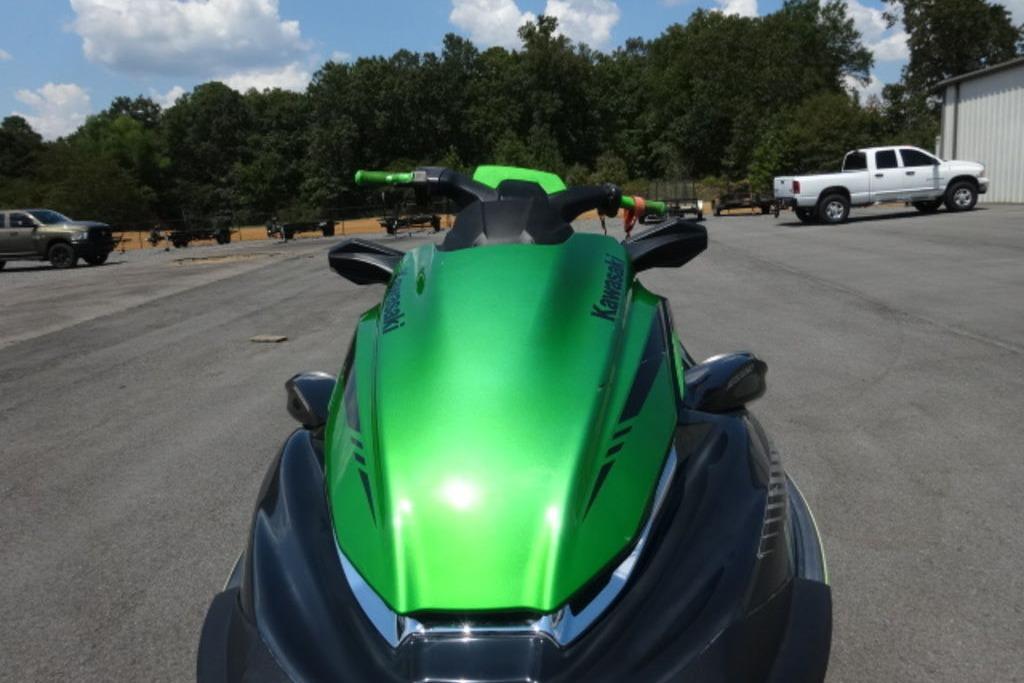 Kawasaki STX160 2020 Kawasaki STX160 jet ski in vibrant green, parked outdoors.