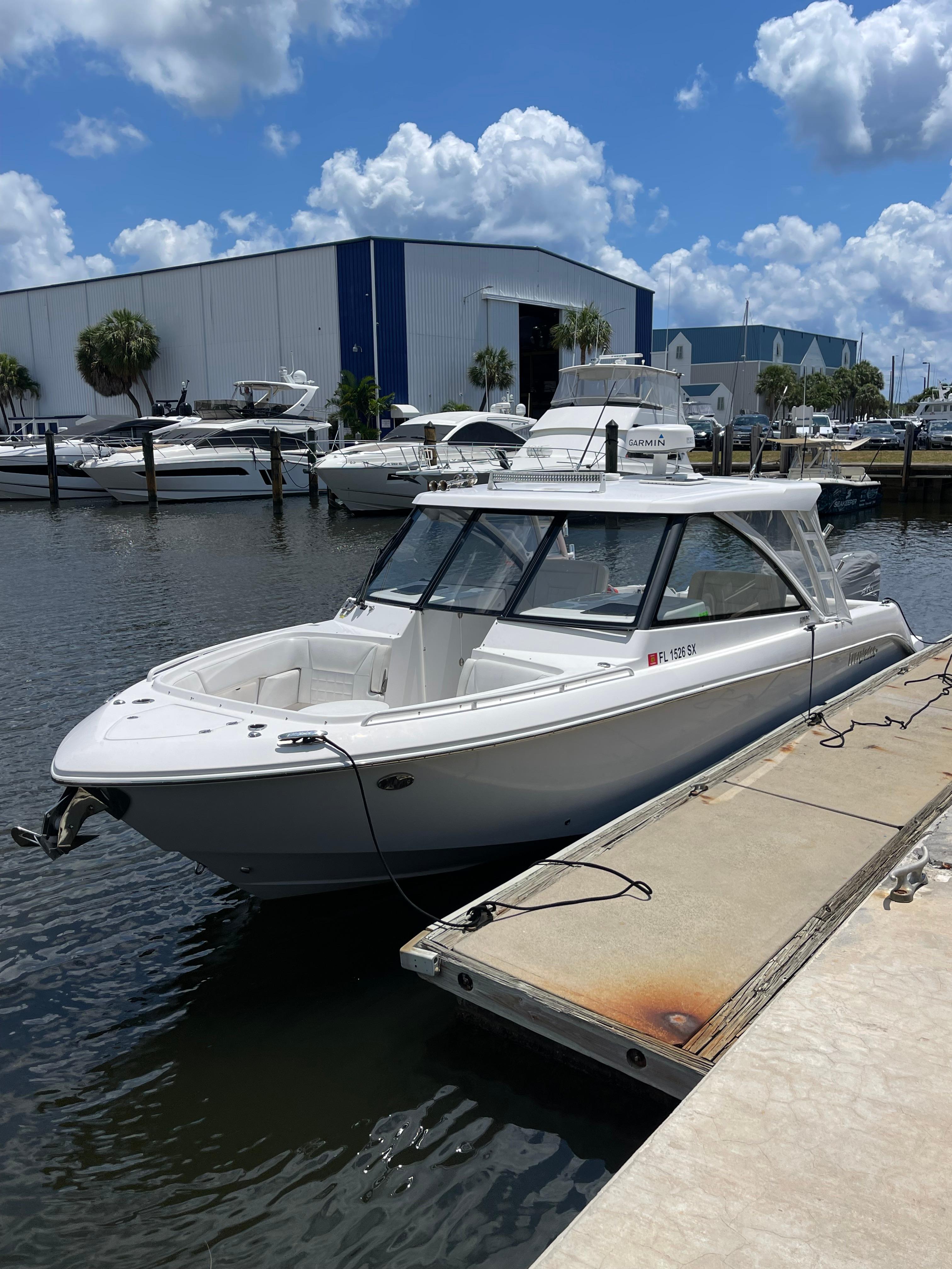 Everglades 340 DC 2019 Everglades 340 DC boat docked at marina under blue sky.