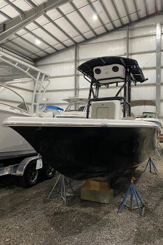Sea Pro 202 2024 Sea Pro 202 boat in storage, black hull, indoor facility.