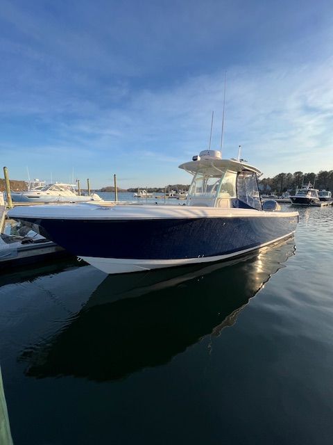 Sailfish 320 CC 2018 Sailfish 320 CC boat docked in calm marina waters.