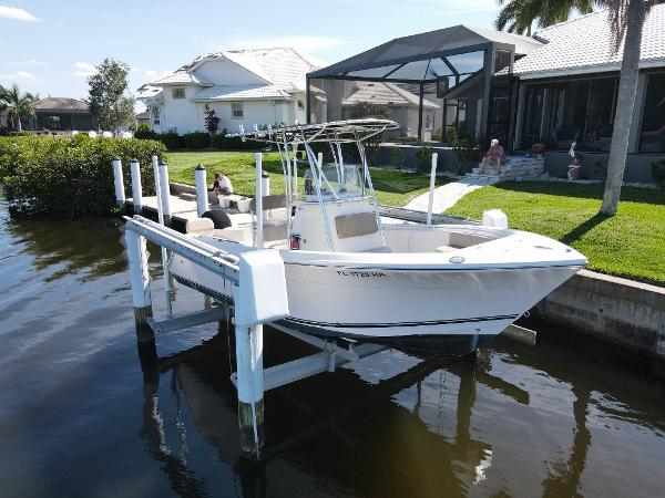 Cobia 217 Center Console 2016 Cobia 217 Center Console boat docked by waterfront homes.