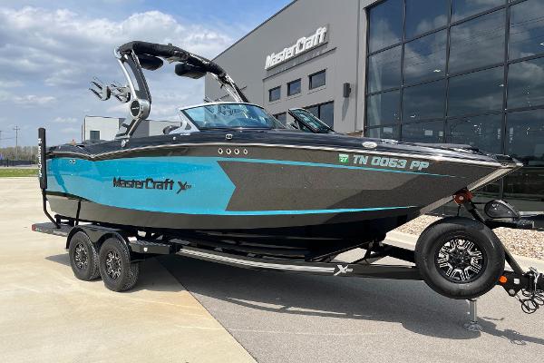 MasterCraft Xstar 2018 MasterCraft XStar boat on trailer, parked outside a modern building.