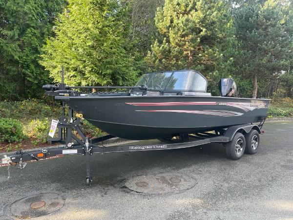 Ranger VX1888 WT 2024 Ranger VX1888 WT boat on trailer, parked outdoors with trees in background.