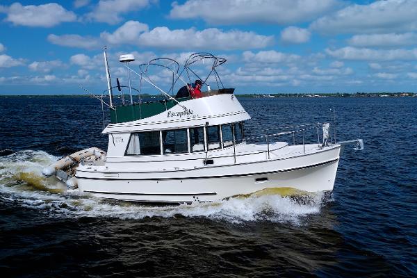 Camano 31 Troll 2004 Camano 31 Troll boat cruising on open water under a blue sky.