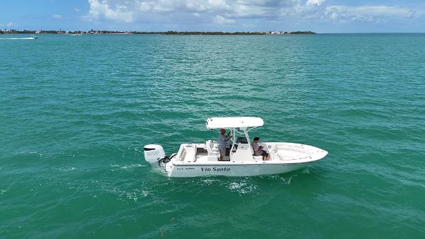 Sea Born LX24 2023 Sea Born LX24 boat cruising on turquoise ocean waters under a clear sky.