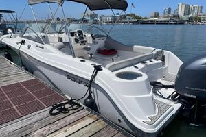 Sea Fox 228 Traveler 2024 Sea Fox 228 Traveler boat docked in a marina with city skyline.