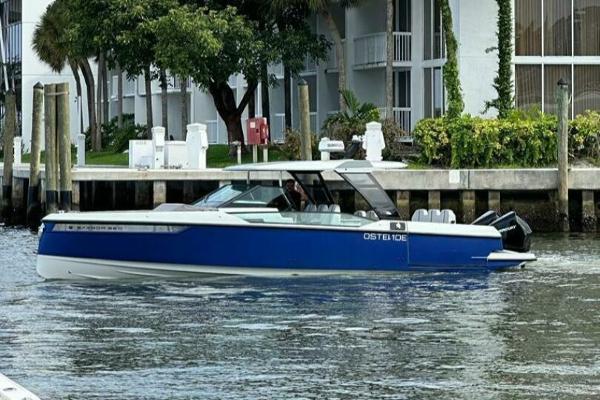 Saxdor 320 GTO 2022 Saxdor 320 GTO boat cruising near a waterfront property.