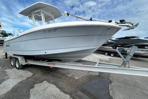 Robalo R242 Center Console 2022 Robalo R242 Center Console boat on trailer, parked outdoors under cloudy sky.