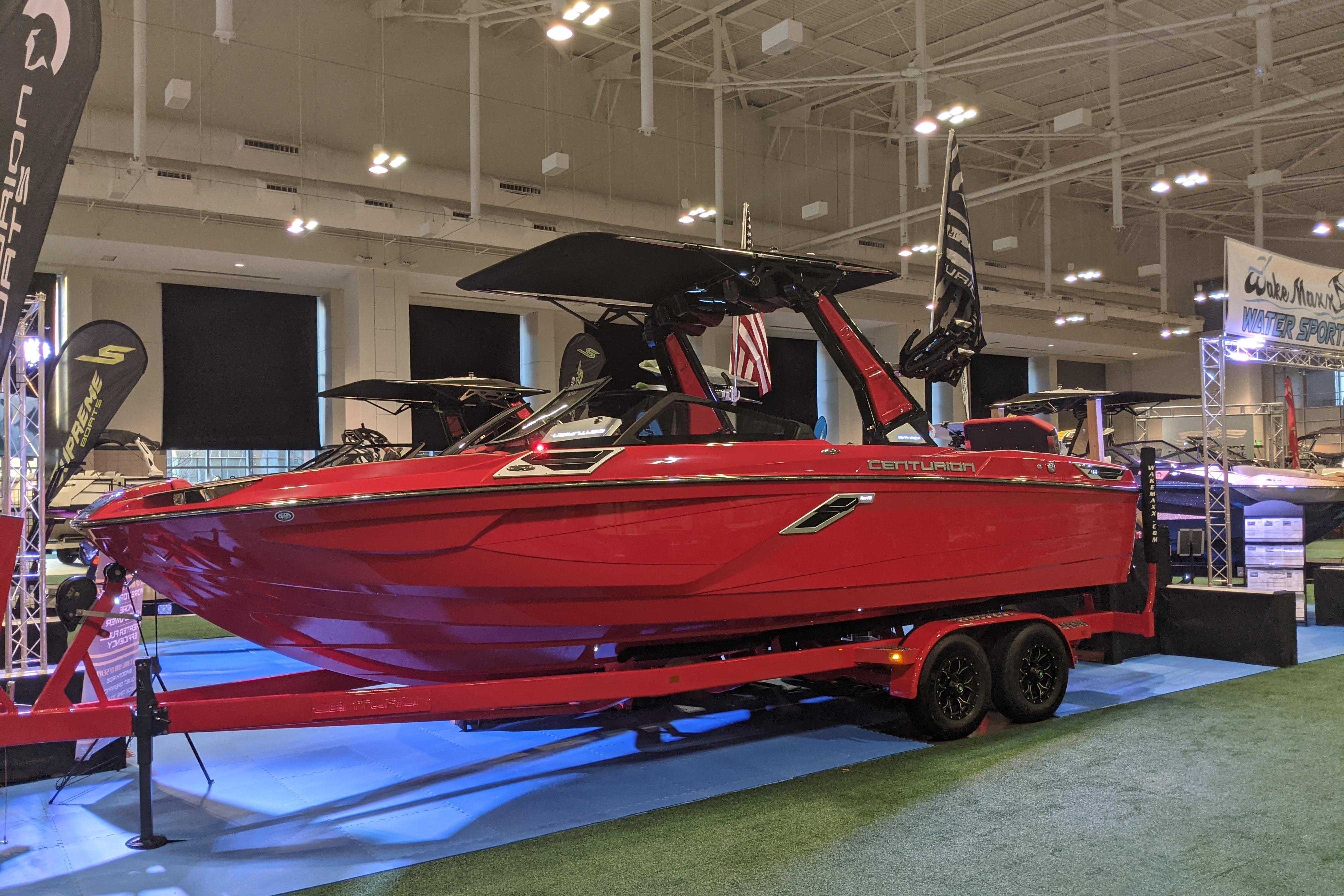 Centurion Ri245 2023 Centurion Ri245 boat displayed indoors on a trailer at a boat show.
