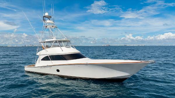 Viking 76 Convertible 2015 Viking 76 Convertible yacht cruising on open sea under clear blue sky.