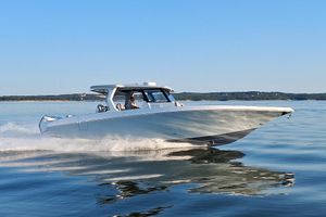 Fountain 38 SCX 2023 Fountain 38 SCX boat cruising on calm water under clear blue sky.