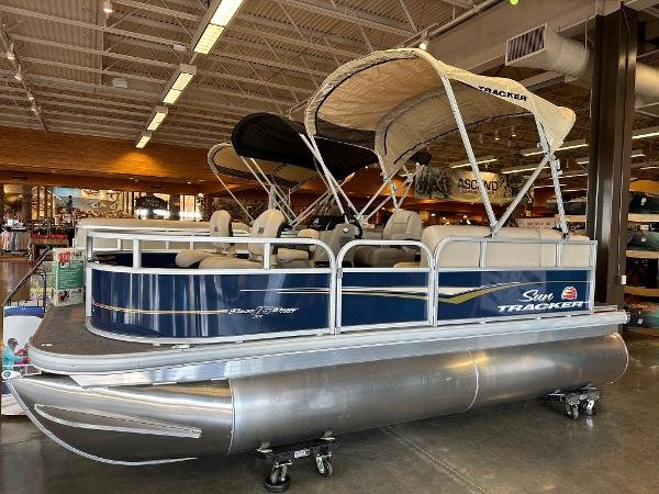 Sun Tracker Bass Buggy 16 XL Select 2025 Sun Tracker Bass Buggy 16 XL Select pontoon boat displayed indoors.
