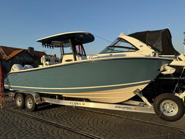 Cobia 265 Open Center Console 2025 Cobia 265 Open Center Console boat on trailer, side view.