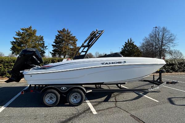 Tahoe T21 2024 Tahoe T21 boat on trailer in parking lot, side view.