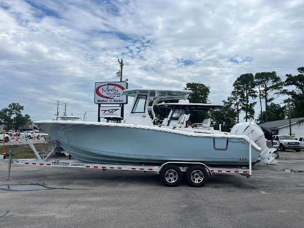Tidewater 282 CC Adventure 2025 Tidewater 282 CC Adventure boat on a trailer at a marina.