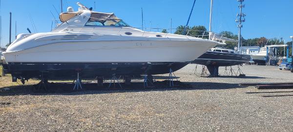 Sea Ray 450 Sundancer 1998 Sea Ray 450 Sundancer yacht on dry dock, sunny day, marina background.