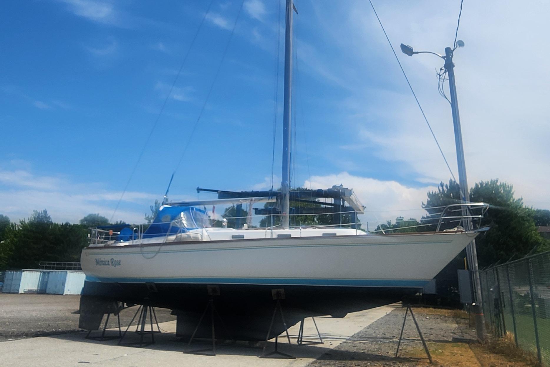 Tartan 37 1982 Tartan 37 sailboat on stands, clear sky background.