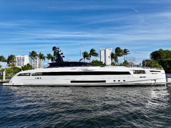 Rossinavi 49M Sport Yacht 2024 Rossinavi 49M Sport Yacht docked, sleek design, blue sky, palm trees in background.