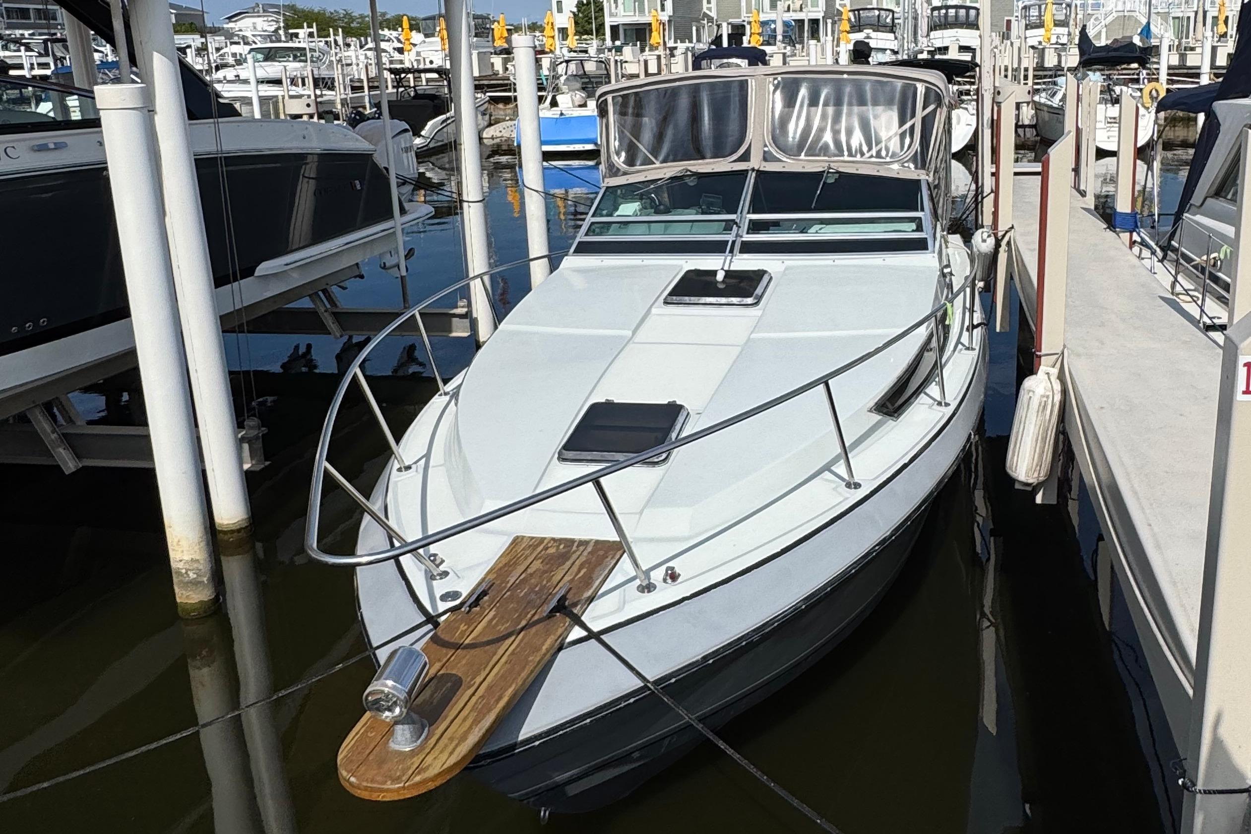 Formula 28 PC 1985 Formula 28 PC boat docked at marina, featuring sleek design and spacious deck.