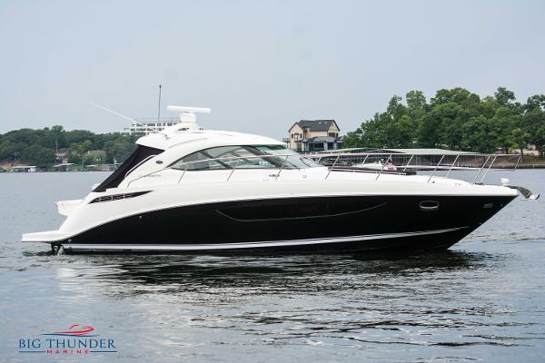 Sea Ray 410 Sundancer 2012 Sea Ray 410 Sundancer yacht on calm water, surrounded by trees and houses.