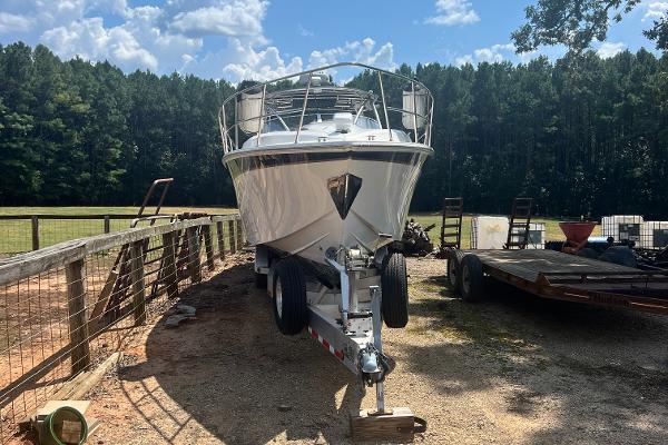 Fountain 38 Sportfish Express Cruiser 2008 Fountain 38 Sportfish Express Cruiser on trailer, parked outdoors near trees.