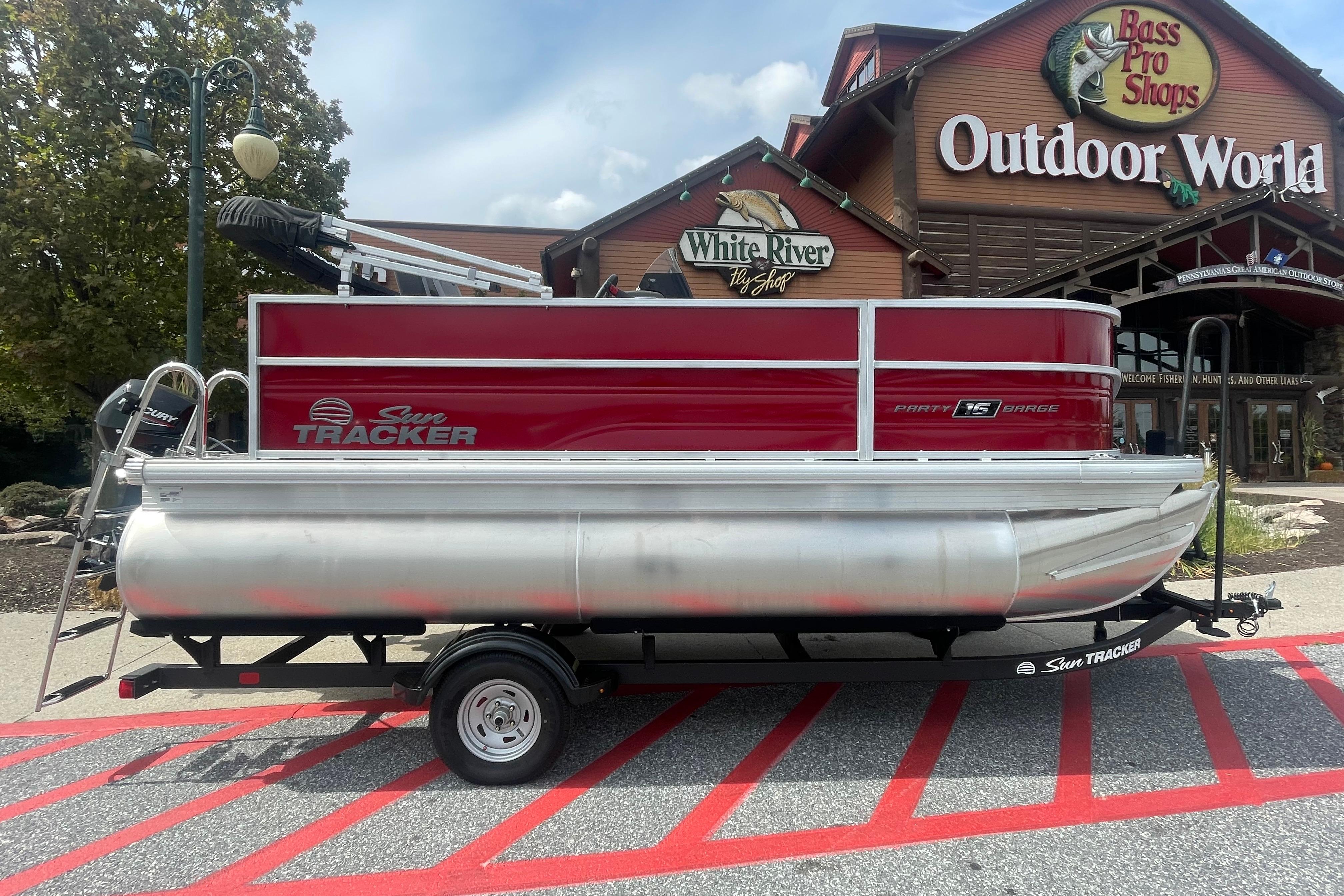 Sun Tracker Party Barge 16 DLX 2026 Sun Tracker Party Barge 16 DLX pontoon boat outside Bass Pro Shops.