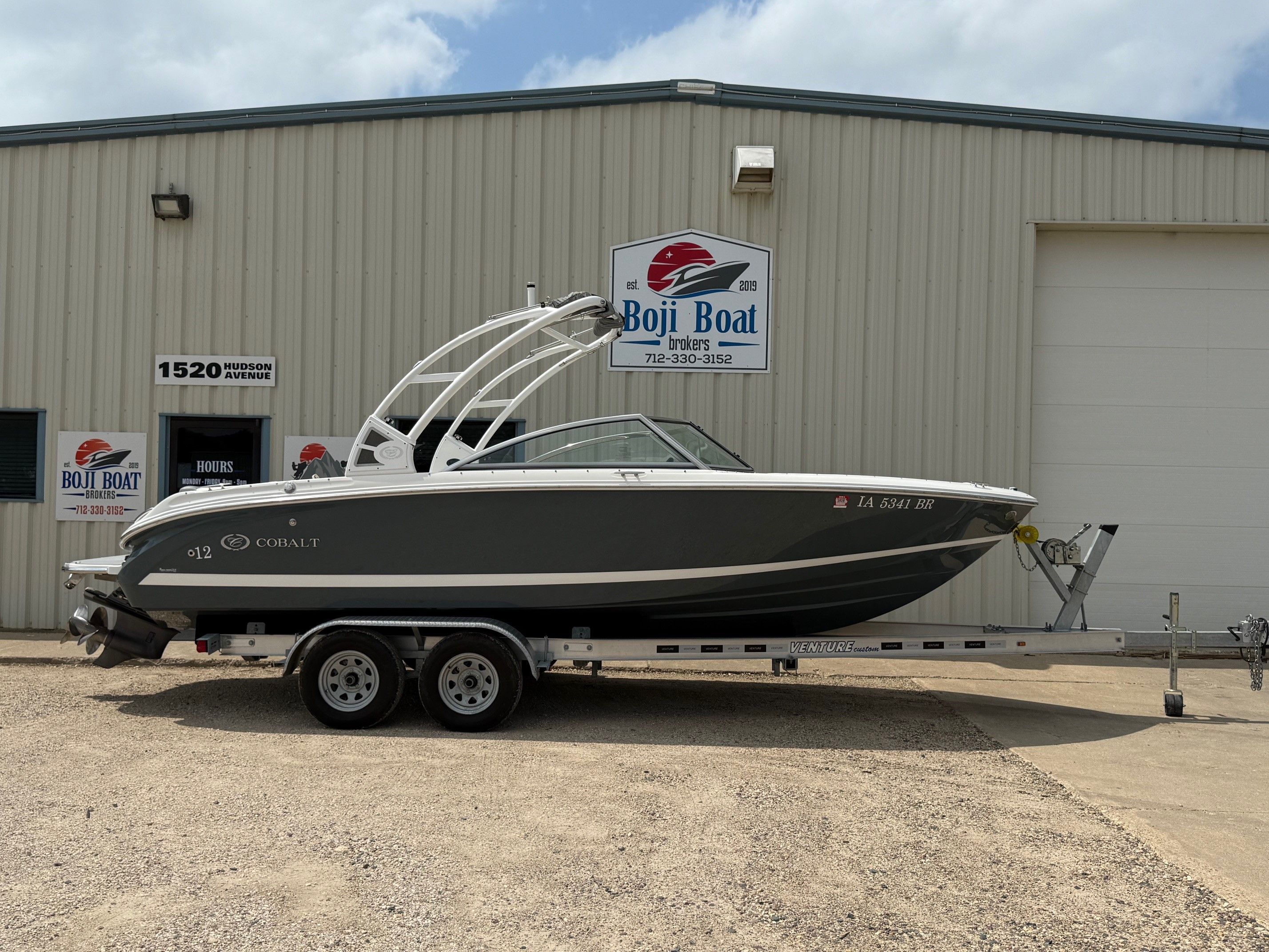Cobalt 220S 2017 Cobalt 220S boat on trailer outside Boji Boat Brokers building.