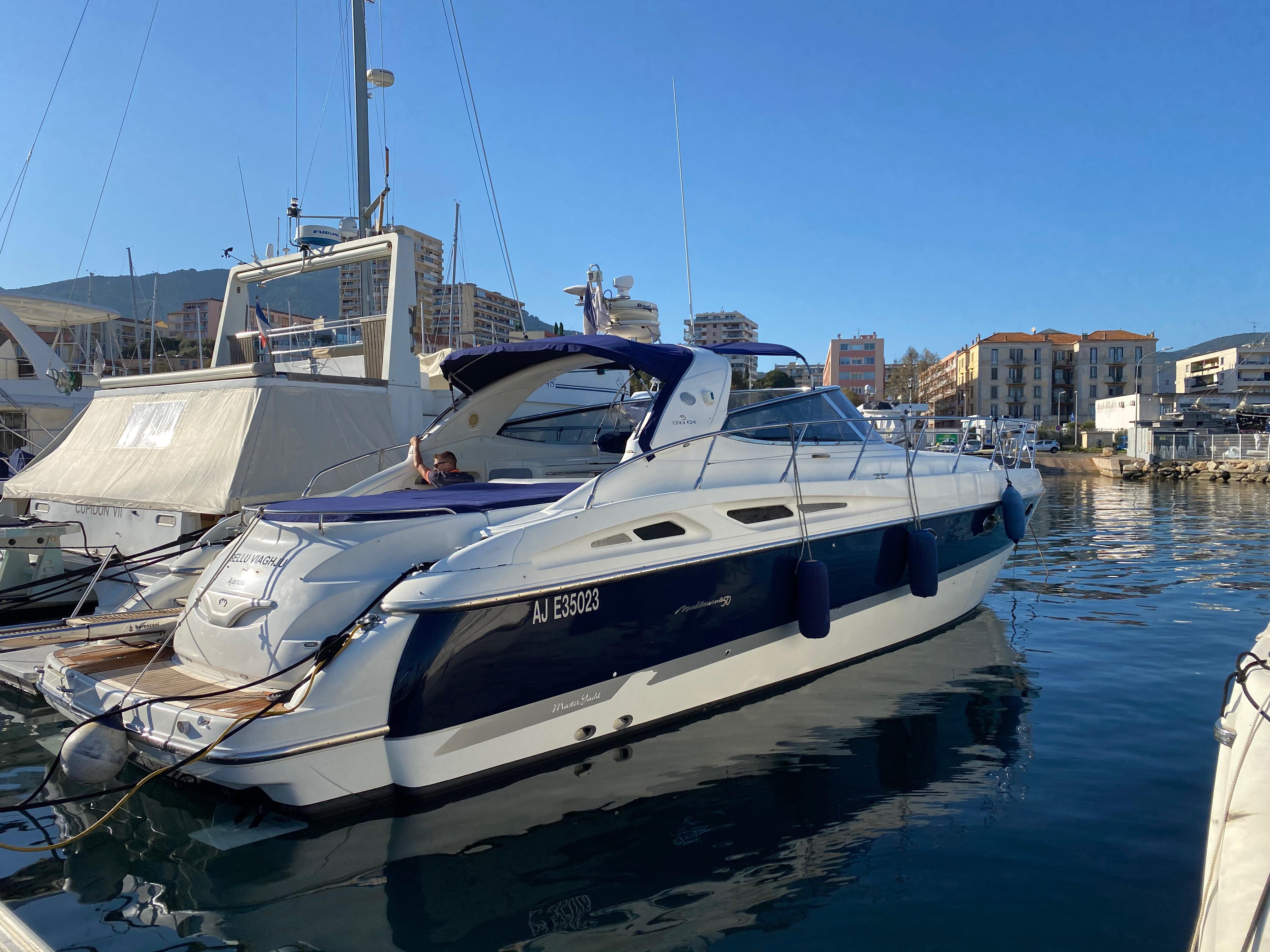 Cranchi Mediterranée 50 2005 Cranchi Mediterranée 50 yacht docked in a marina under clear blue skies.