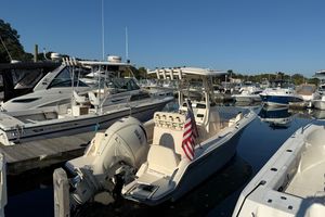Grady-White Fisherman 216 2024 Grady-White Fisherman 216 boat docked in a marina, featuring an American flag.